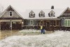 rustic-craftsman-house-plan-covered-in-snow