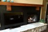 fireplace-with-wood-pannel-and-tv-slot-mountain-home