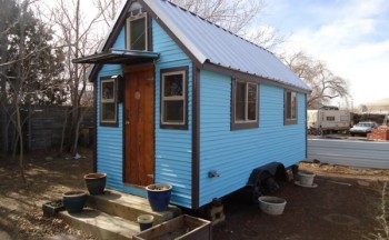 rolling blue tiny house on wheels