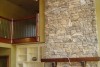 open-living-room-stone-fireplace-loft
